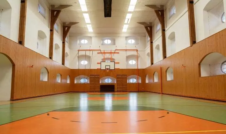 Calculate the cost of an indoor basketball court for a school or a