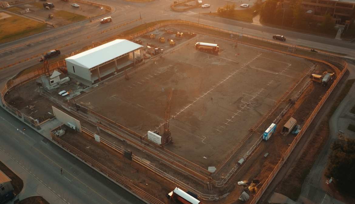 Aerial view of a sports facility under construction with earthworks and equipment visible