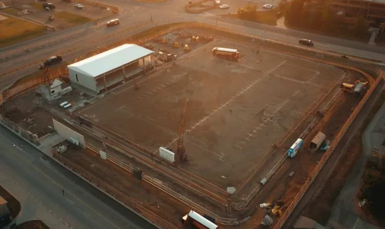 Aerial view of a sports facility under construction with earthworks and equipment visible
